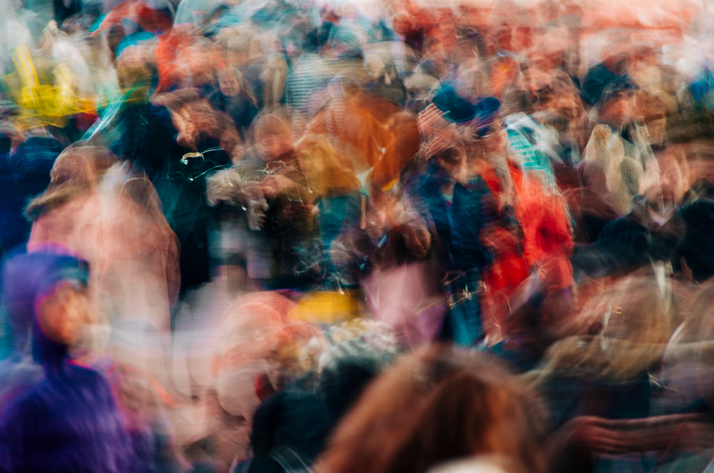 A blurred crowd in motion, colours blending together